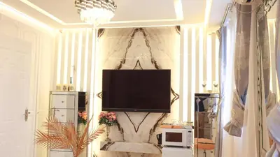 a living room with a television on a wall at Reimi Mondo9 in Tokyo