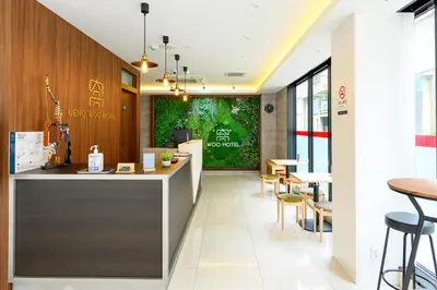 a lobby of a restaurant with a counter and chairs at Ueno Woo Hotel in Tokyo