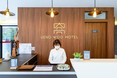 a woman wearing a face mask in a hotel lobby at Ueno Woo Hotel in Tokyo