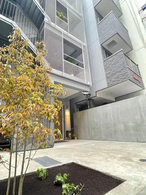 a building with a tree in front of it at Hotel Apreton in Tokyo
