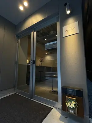 an entrance to an office with a glass door at Hotel Apreton in Tokyo