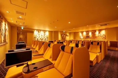 a conference room with chairs and a flat screen tv at Sauna & Cabin Thermae-yu Nishiazabu in Tokyo